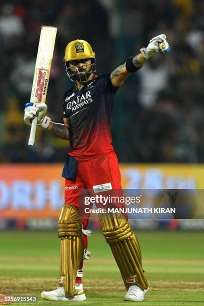 Royal Challengers Bangalore's Virat Kohli celebrates after scoring a century during the Indian Premier League Twenty20 cricket match between Royal...