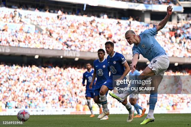 Manchester City's Norwegian striker Erling Haaland shoots but fails to score during the English Premier League football match between Manchester City...