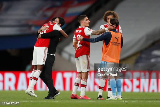 Ainsley Maitland-Niles of Arsenal and Mikel Arteta, Manager of Arsenal embrace following the FA Cup Semi Final match between Arsenal and Manchester...