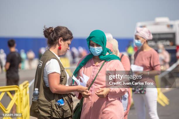 Female seasonal worker passes passport control before boarding back to Morocco at Palos de la Frontera port on July 18, 2020 in Palos de la Frontera,...