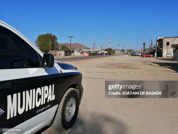 Members of the army and police secure the perimeter at the site of a long-gun attack on a group of amateur rally drivers in Ensenada, Mexico, on May...