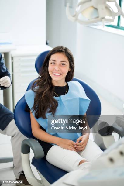 visiting dentist for a routine checkup - dentist's chair stock pictures, royalty-free photos & images