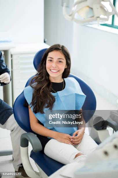 visiting dentist for a routine checkup - cadeira de dentista imagens e fotografias de stock