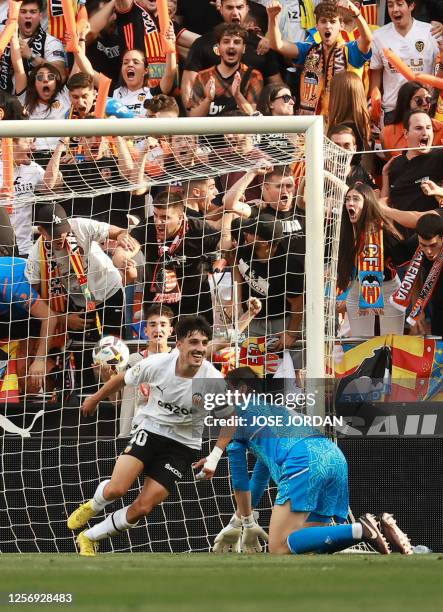 Valencia's Spanish forward Diego Lopez scores the opening goal during the Spanish league football match between Valencia CF and Real Madrid CF at the...