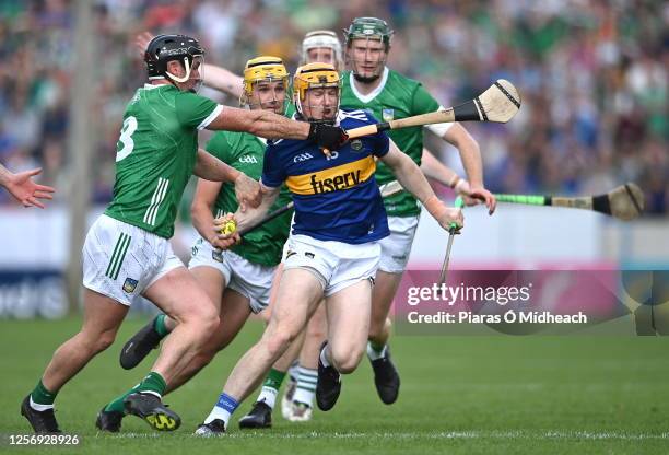 Tipperary , Ireland - 21 May 2023; Jake Morris of Tipperary is tackled by Darragh O'Donovan of Limerick, left, during the Munster GAA Hurling Senior...