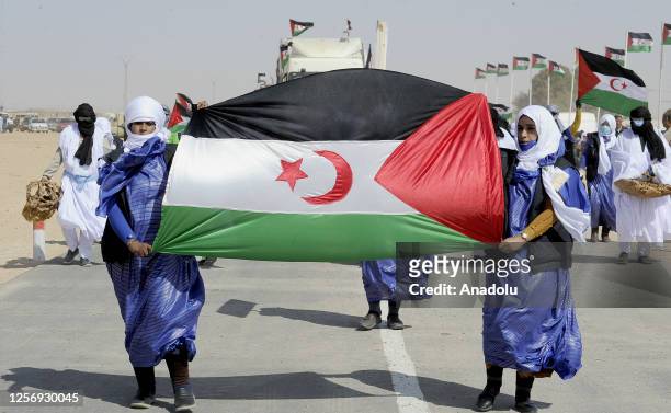 Sahrawi women attend a parade celebrating the 50th anniversary of the Polisario Front and the outbreak of the armed struggle for the independence of...