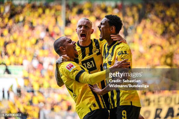 Scorer Sebastien Haller of Dortmund celebrates his team's first goal with Donyell Malen and Marius Wolf during the Bundesliga match between FC...