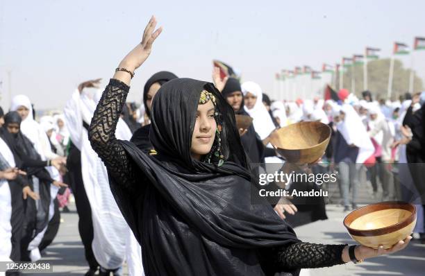 Sahrawi women attend a parade celebrating the 50th anniversary of the Polisario Front and the outbreak of the armed struggle for the independence of...