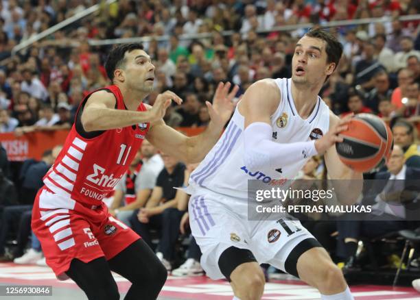 Real Madrid's Mario Hezonja vies with Olympiacos' Kostas Sloukas during the Euroleague basketball final four final match between Olympiacos Piraeus...