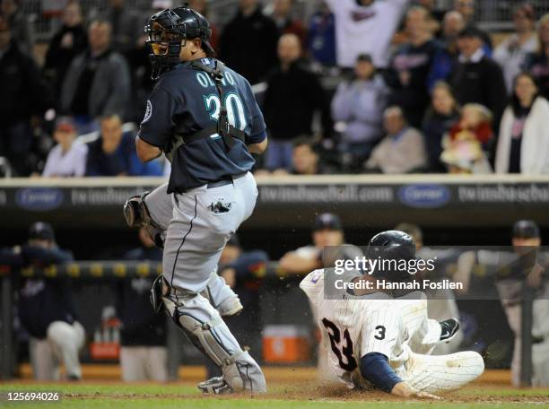 Rene Tosoni of the Minnesota Twins is forced out at home by Miguel Olivo of the Seattle Mariners in the ninth inning on September 20, 2011 at Target...