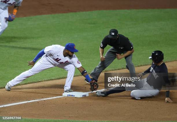 Eduardo Núñez of the New York Mets tags out Thairo Estrada of the New York Yankees during their preseason game at Citi Field on July 18, 2020 in New...