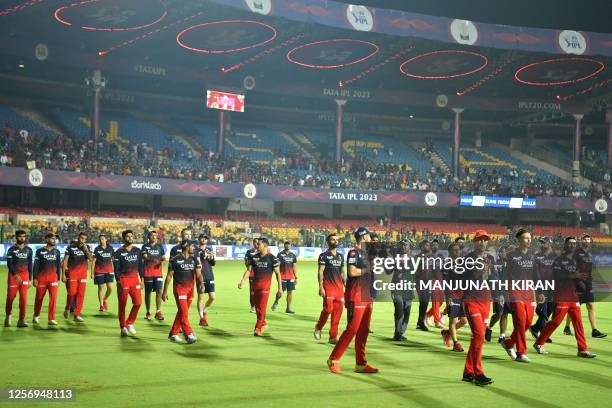 Royal Challengers Bangalore's team members take a lap of honour at the end of the Indian Premier League Twenty20 cricket match between Royal...