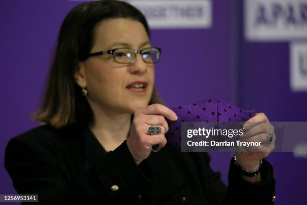 Victorian Health Minister Jenny Mikakaos speaks to the media and displays her face mask during the daily briefing on July 19, 2020 in Melbourne,...