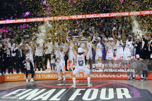 Real Madrid's players celebrate with the trophy after winning the Euroleague basketball final four final match between Olympiacos Piraeus and Real...