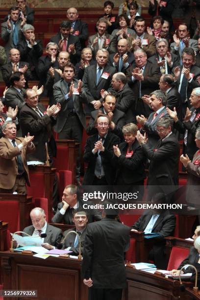 French socialist deputies applaud the head of the French socialist party group at the National assembly Jean-Marc Ayrault who interrupted French...