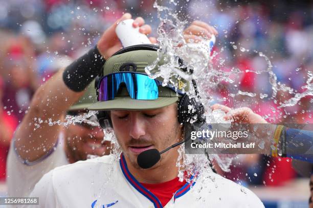 Bryson Stott of the Philadelphia Phillies has water poured on him after the game against the Chicago Cubs at Citizens Bank Park on May 21, 2023 in...