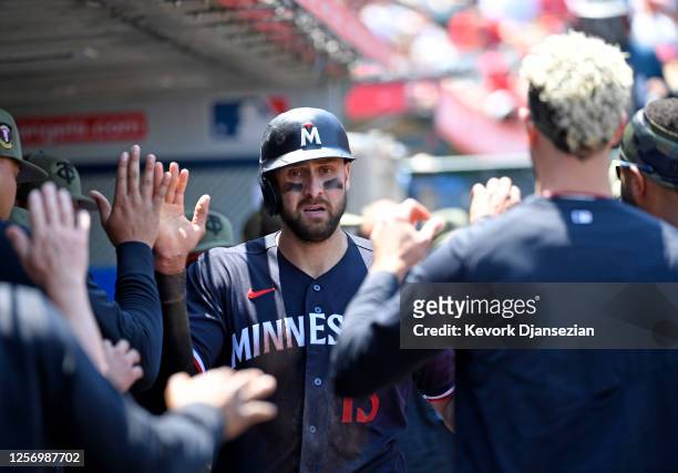 Joey Gallo of the Minnesota Twins is congratulated in the dugout after scoring a run against starting pitcher Shohei Ohtani of the Los Angeles Angels...