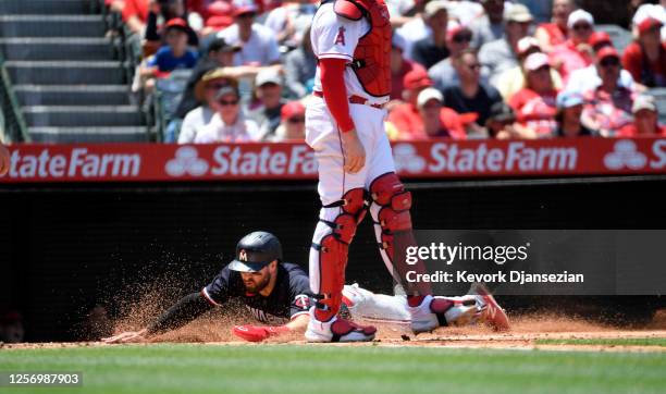 Joey Gallo of the Minnesota Twins scores a run against starting pitcher Shohei Ohtani of the Los Angeles Angels during the third inning at Angel...