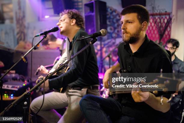 rock band playing on the concert - pop music stock pictures, royalty-free photos & images