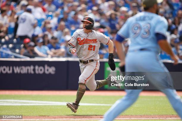 Austin Hays of the Baltimore Orioles scores off a Terrin Vavra single in the eleventh inning of their MLB game against the Toronto Blue Jays at...