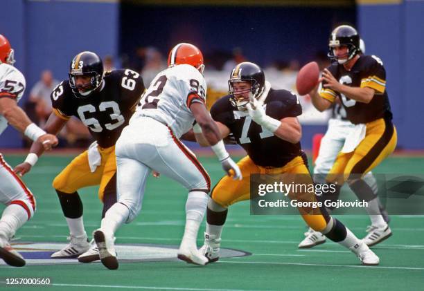 Offensive lineman Tom Ricketts and center Dermontti Dawson of the Pittsburgh Steelers block against linebacker Clay Matthews and defensive lineman...