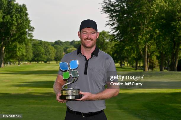 Grayson Murray poses with the AdventHealth Championship trophy at Blue Hills Country Club on May 21, 2023 in Kansas City, Missouri.