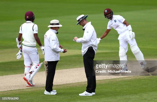 Umpires Michael Gough and Richard Illingworth sanitise the ball after saliva is accidentally added to it during Day Four of the 2nd Test Match in the...