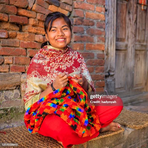 nepali young woman  kniting a wool scarf in bhaktapur. - nepal women stock pictures, royalty-free photos & images