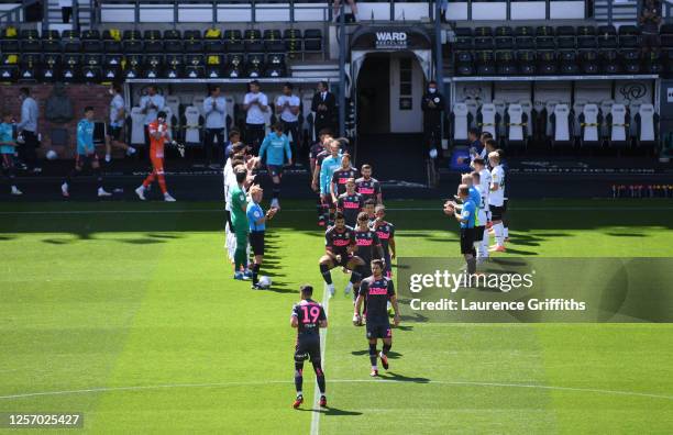 Derby County line up for a guard of honor for Leeds United players to honor their title ahead of the Sky Bet Championship match between Derby County...