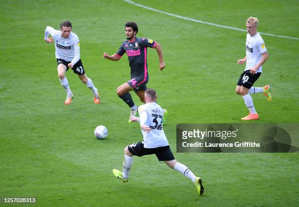 Pascal Struijk of Leeds United runs with the ball as Wayne Rooney of Derby County challenges during the Sky Bet Championship match between Derby...