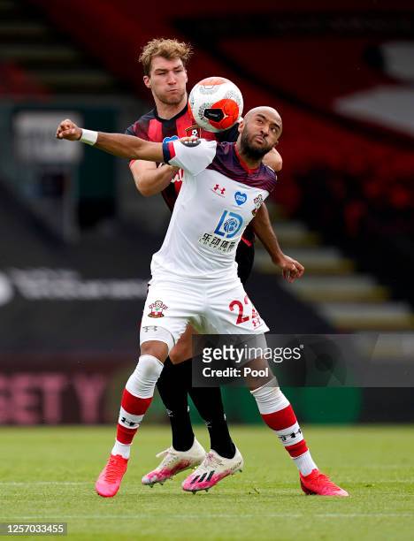 Jack Stacey of AFC Bournemouth battles for possession with Nathan Redmond of Southampton during the Premier League match between AFC Bournemouth and...
