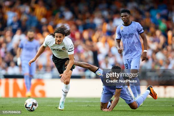 Edinson Cavani of Valencia CF competes for the ball with Eder Militao of Real Madrid CF during the LaLiga Santander match between Valencia CF and...