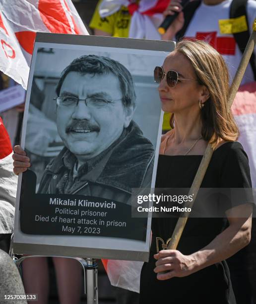 Unified in solidarity, members of the local Belarusian and Ukrainian diaspora, hold pictures of detained people in Belarus, at the main Market Square...