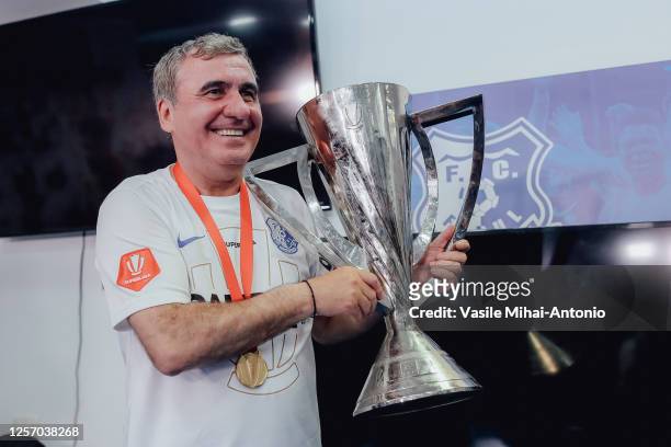 Gheorghe Hagi of Farul Constanta poses with the trophy during the Round 9 of Liga 1 Romania Play-off match between Farul Constanta and FCSB at...