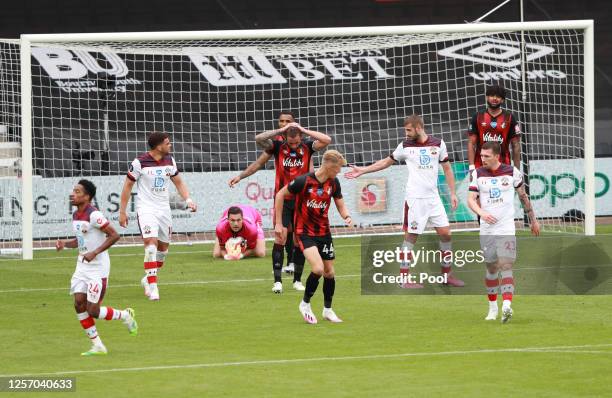 Callum Wilson of AFC Bournemouth reacts after a missed chance as Alex McCarthy of Southampton collects the ball during the Premier League match...