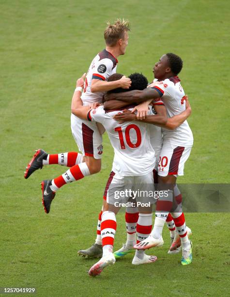 Che Adams of Southampton celebrates with his team after he scores his sides second goal during the Premier League match between AFC Bournemouth and...