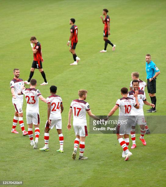 Che Adams of Southampton celebrates with his team after he scores his sides second goal during the Premier League match between AFC Bournemouth and...