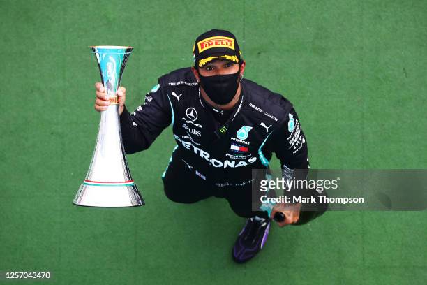 Race winner Lewis Hamilton of Great Britain and Mercedes GP celebrates on the podium after the Formula One Grand Prix of Hungary at Hungaroring on...