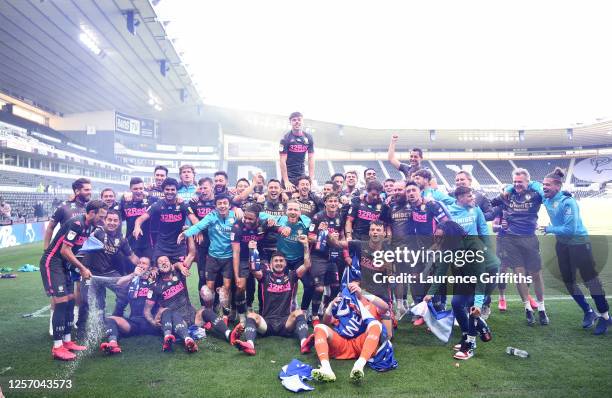 Leeds United celebrate winning the league and promotion to the premier league during the Sky Bet Championship match between Derby County and Leeds...