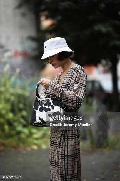 Lea Neumann wearing Prada bag, Weekday dress and Kangol bucket hat on July 15, 2020 in Berlin, Germany.