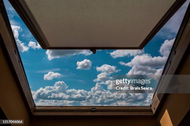 view of clouds in sky through open window - open sky stockfoto's en -beelden