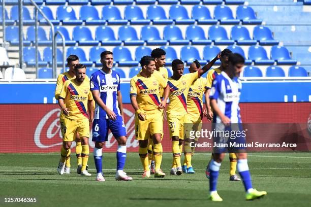 Ansu Fati of FC Barcelona celebrates with teammates after scoring his sides first goal during the Liga match between Deportivo Alaves and FC...