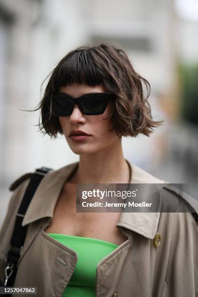 Lea Neumann wearing Burberry vintage coat, Prada bag, Bershka two piece, Weekday shades on July 15, 2020 in Berlin, Germany.