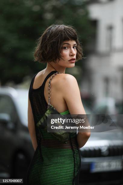 Lea Neumann wearing Bershka two pieces, Prada bag and vintage mesh top on July 15, 2020 in Berlin, Germany.