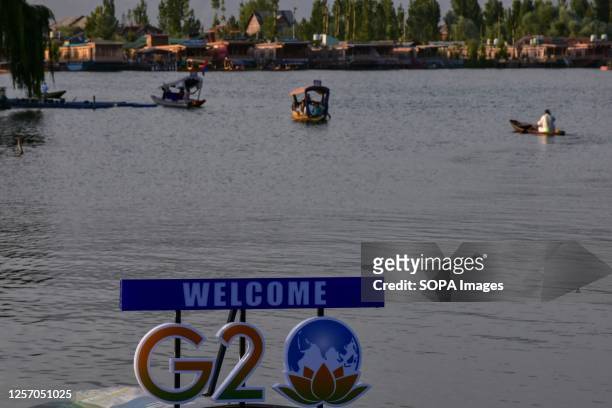 Logo is seen installed on top of a boat as Kashmiri boatmen row their boats across Dal lake ahead of the G20 Tourism meeting in Srinagar. Security...
