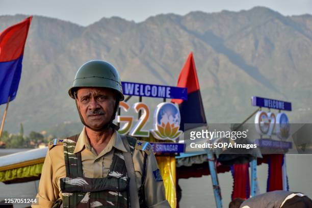Paramilitary trooper stands guard on the banks of Dal lake ahead of the G20 Tourism meeting in Srinagar. Security has been beefed up across the...