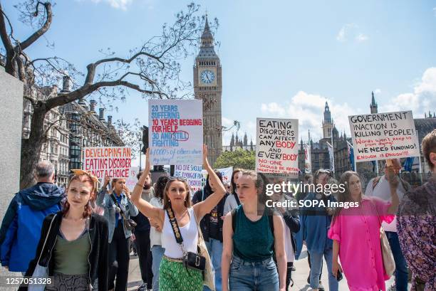 Protesters hold placards expressing their opinion during the eating disorder demonstration. Dump The Scales campaign staged a march from Trafalgar...