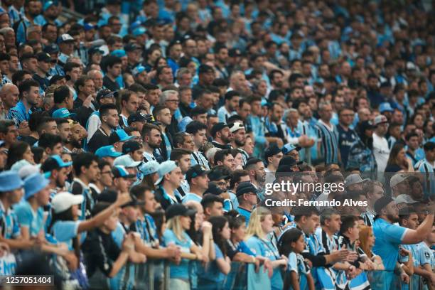 Gremio fans cheer for their team during a Brasileirao match between Gremio and Internacional at Arena do Gremio on May 21, 2023 in Porto Alegre,...