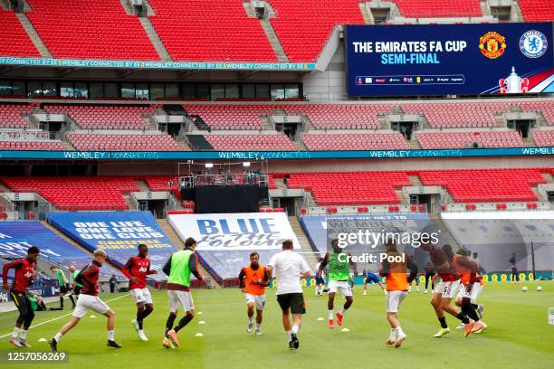 Manchester United warm up ahead of the FA Cup Semi Final match between Manchester United and Chelsea at Wembley Stadium on July 19, 2020 in London,...