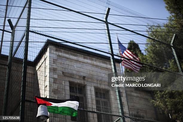 Palestinian flag hangs on the fence of the US General Consulate in east Jerusalem during a protest against US' interference in the Palestinian bid...